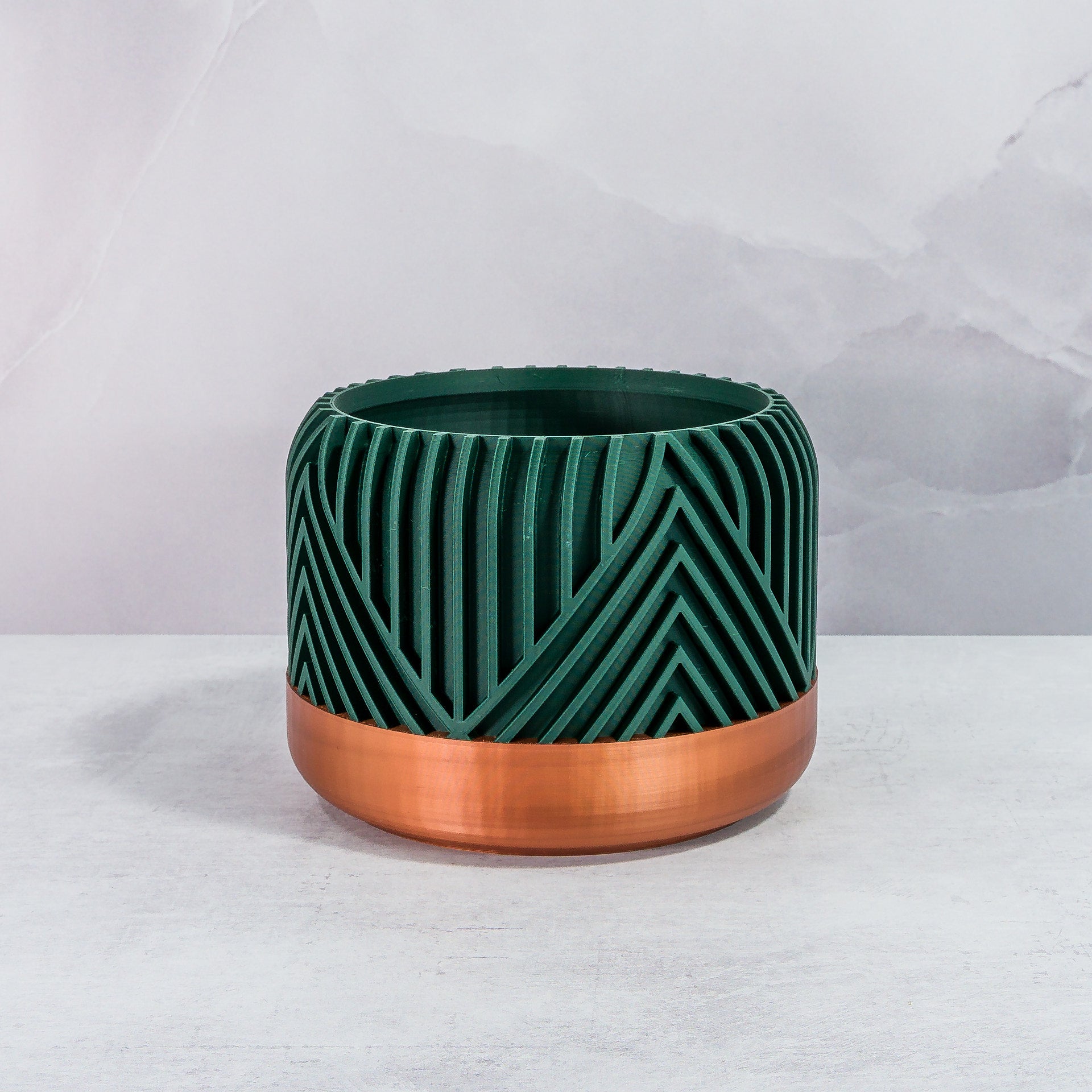 Front Facing: "VERTI planter with copper base and deep green forest pattern, front view."
